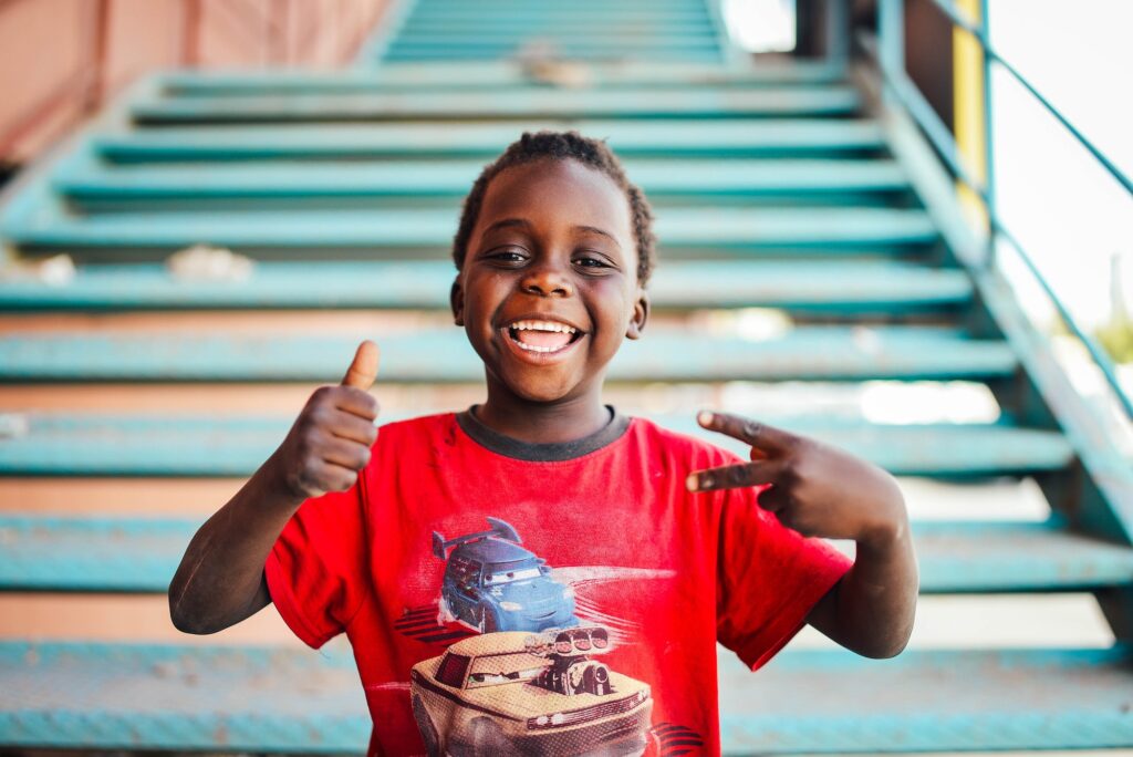 Happy, well-rested boy giving a thumbs up, a goal for parents addressing mouth breathing in kids